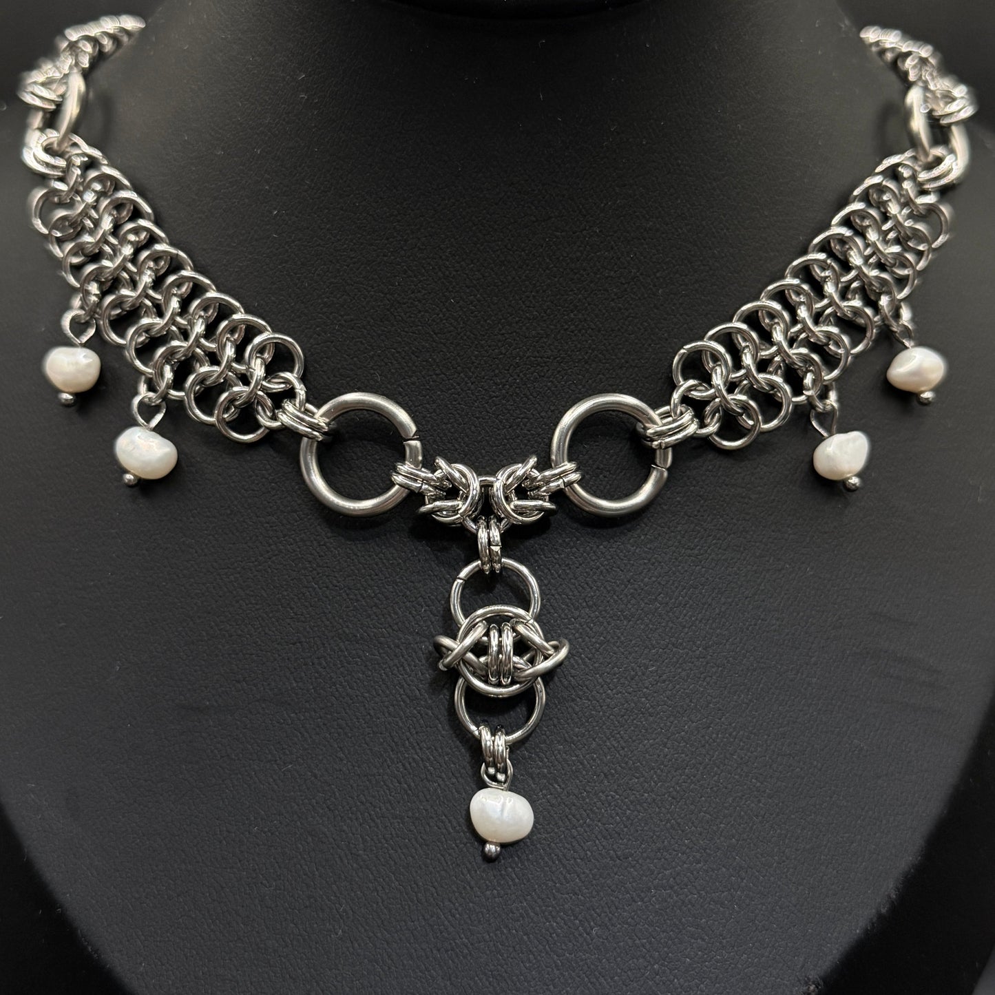 Silver chain necklace with freshwater pearl beads on a black mannequin bust