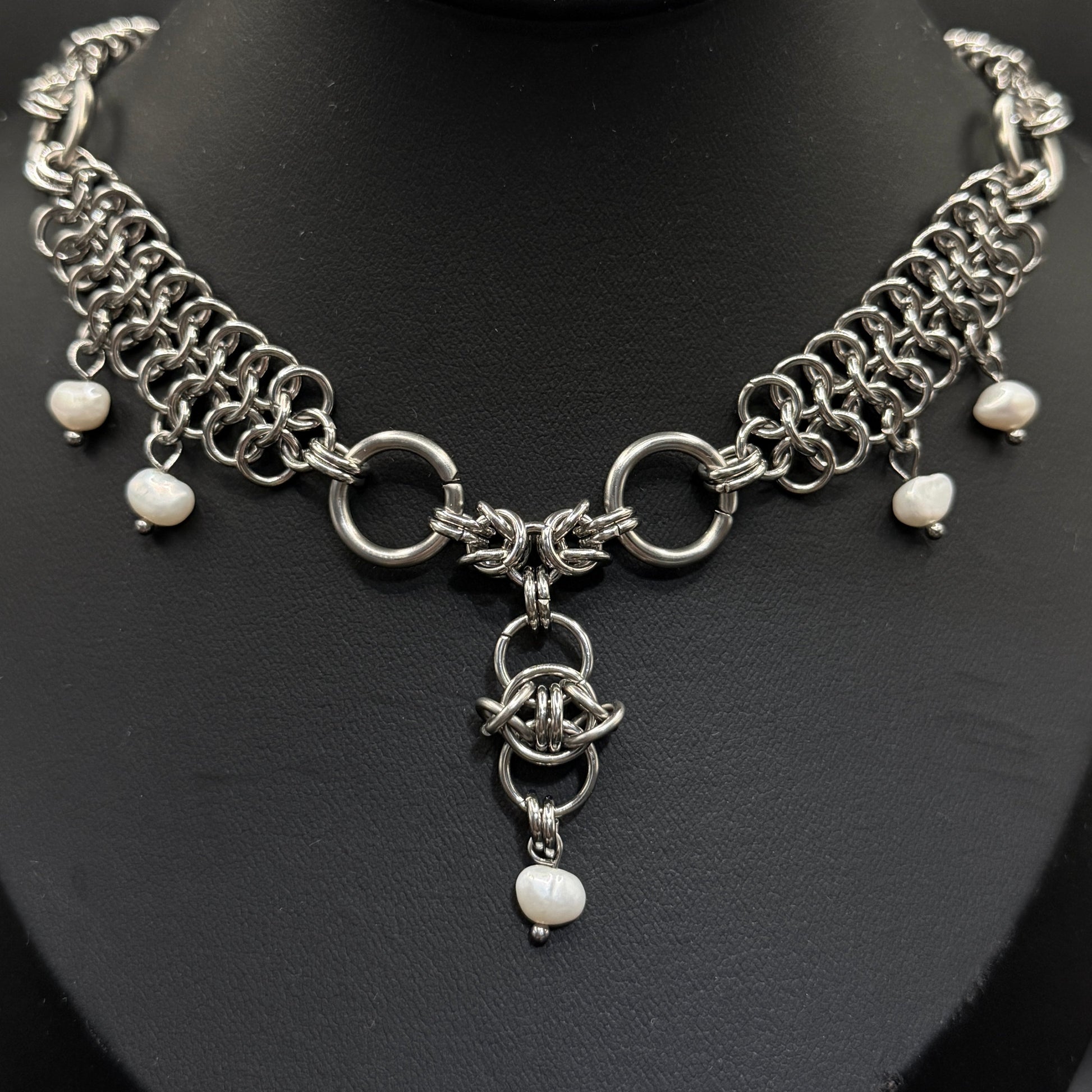 Silver chain necklace with freshwater pearl beads on a black mannequin bust