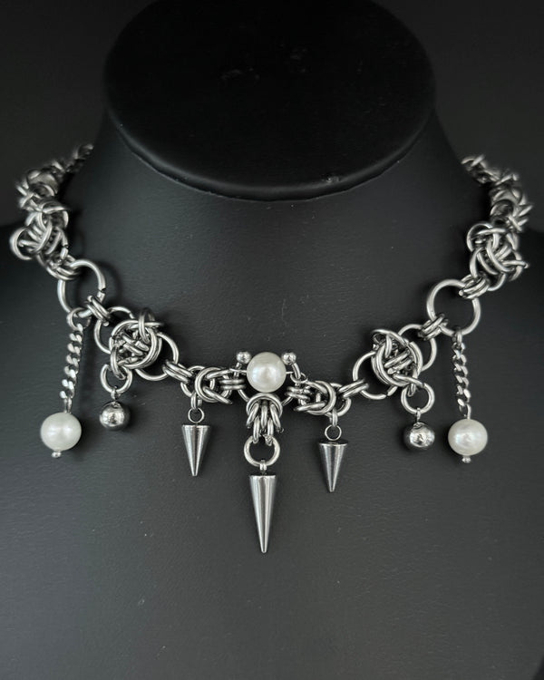 Close-up of a handmade chainmail necklace featuring intricate stainless steel links.