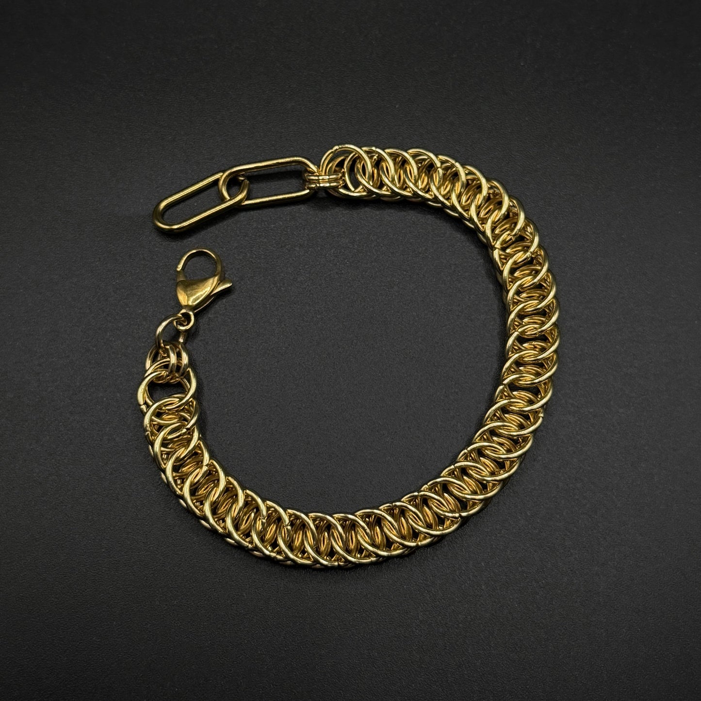 Gold chainmail bracelet on a black background