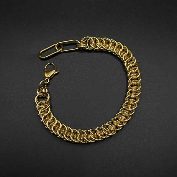 Gold chainmail bracelet on a black background