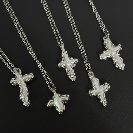 closeup of handmade gothic freshwater pearl cross necklaces molten metal design 