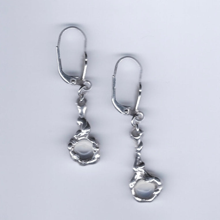 Pair of silver earrings on a light gray background