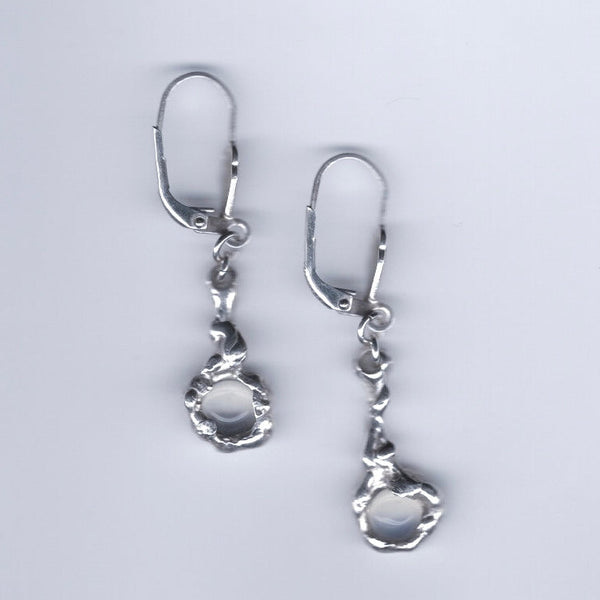 Pair of silver earrings on a light gray background