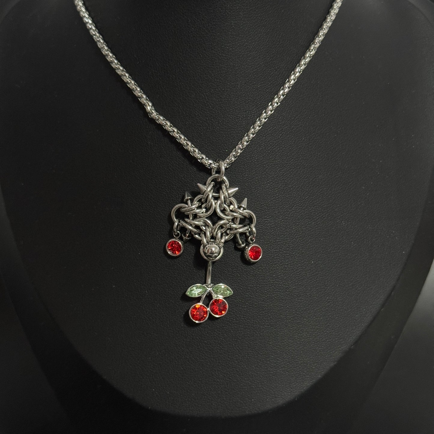 Pierced Cherry necklace displayed on mannequin side view 